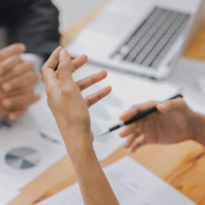 Group of businessmen is discussing in the office about the company profit figures.